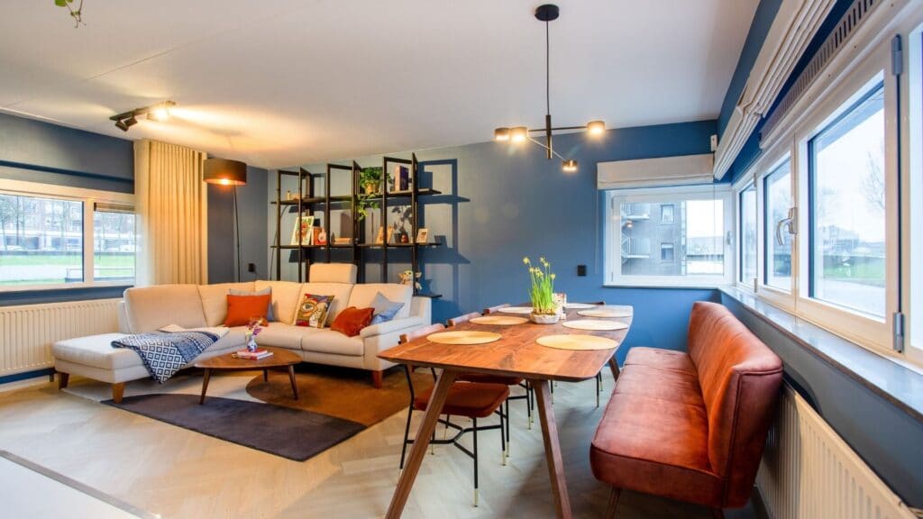 Living Room and dining room blue walls black shelf 